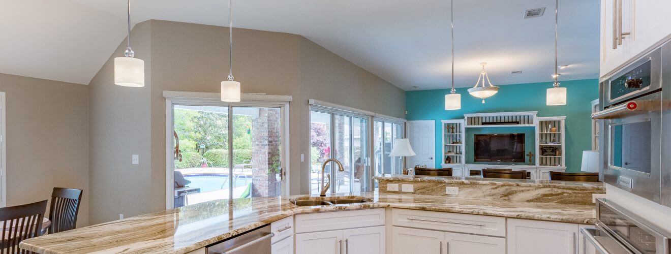 Open floor plan kitchen and living room with Shaker cabinets