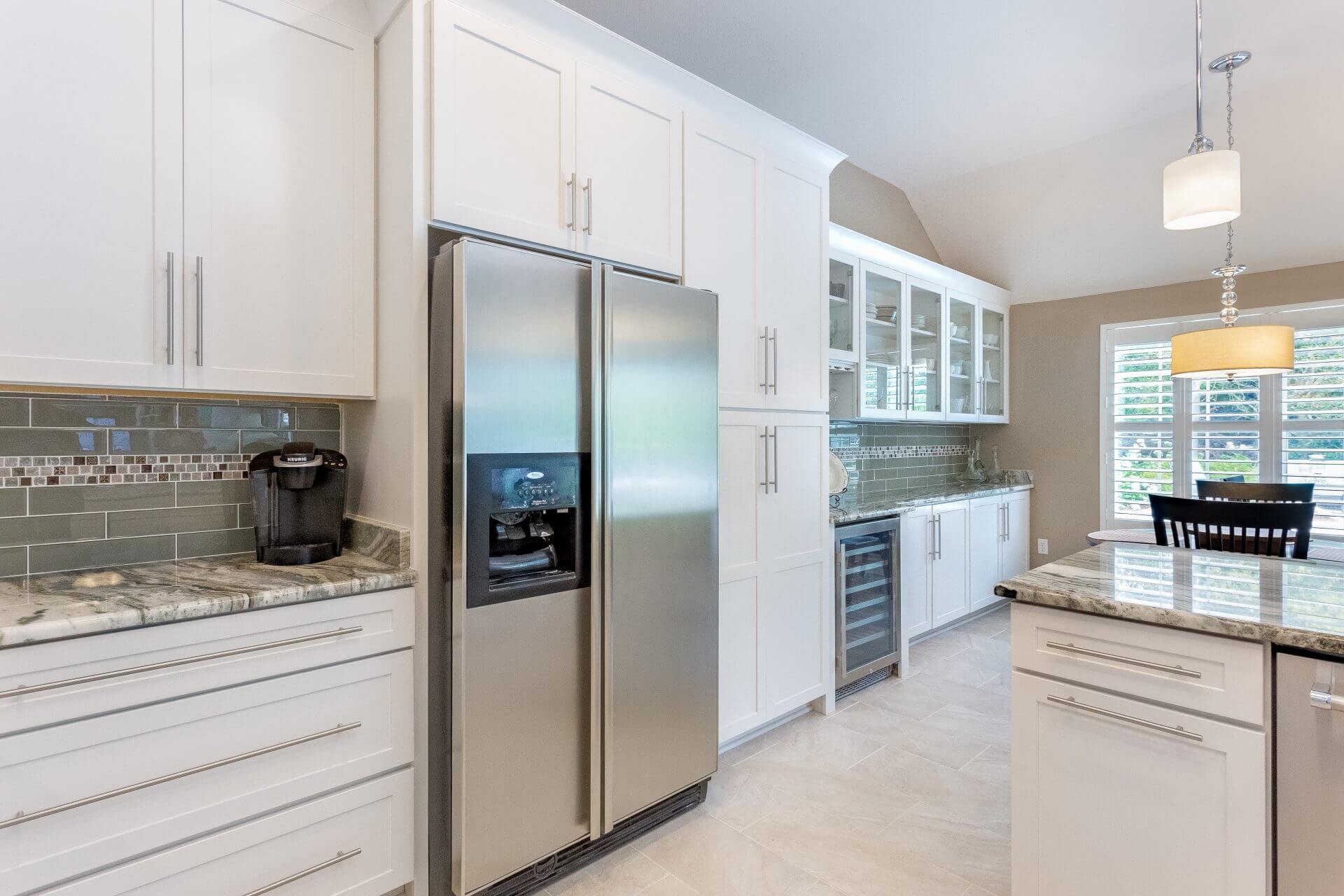 Modern kitchen and dining room with Shaker cabinets and plantation shutters