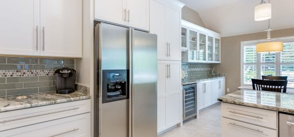 Modern kitchen and dining room with Shaker cabinets and plantation shutters